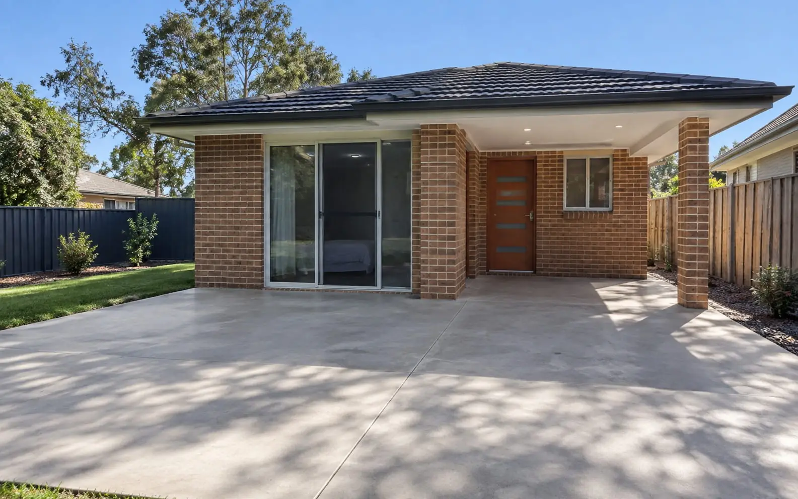 Brick granny flat with a concrete slab and patio in Wollongong