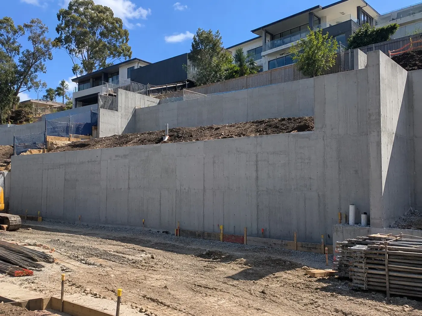 Tall off-form concrete retaining walls on a terraced Wollongong building site