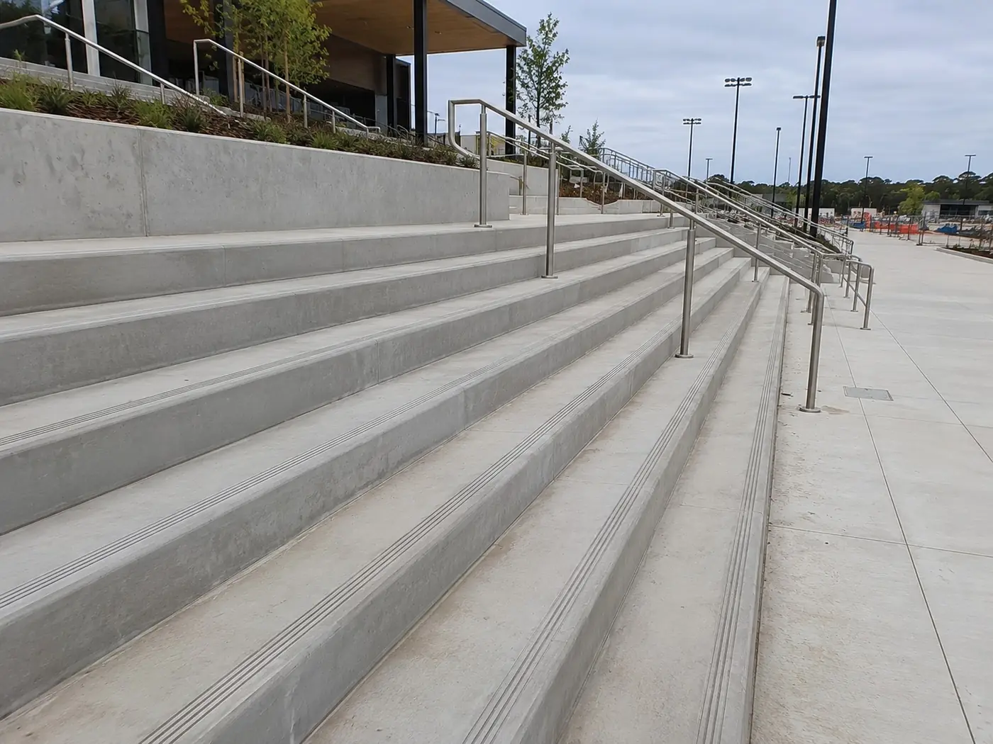 Concrete stairs with contrasting nosings and handrails